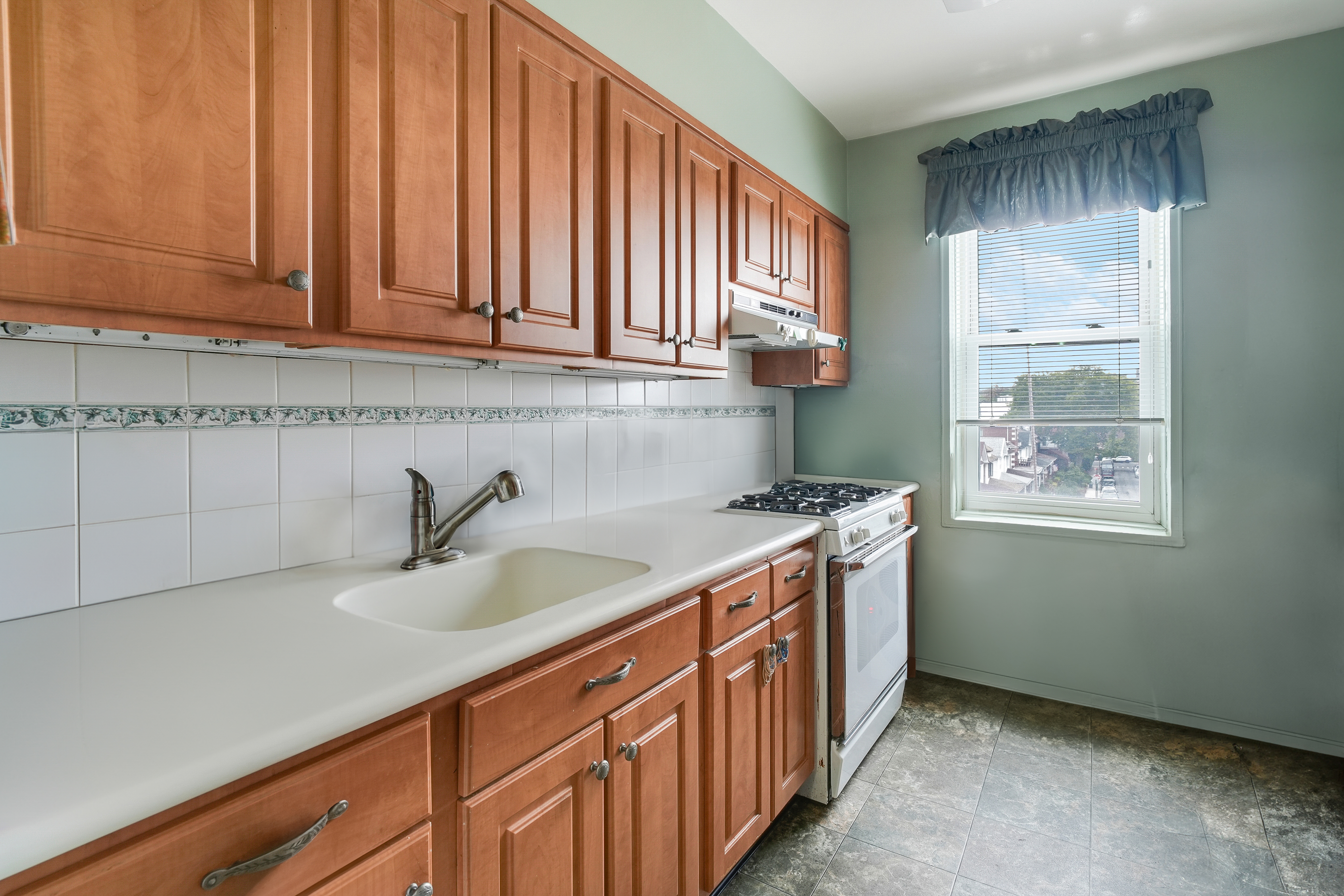 9801 Shore Road, Unit 3E Brooklyn, NY 11209 - Photo 5 of 9 a kitchen with a sink cabinets and a window