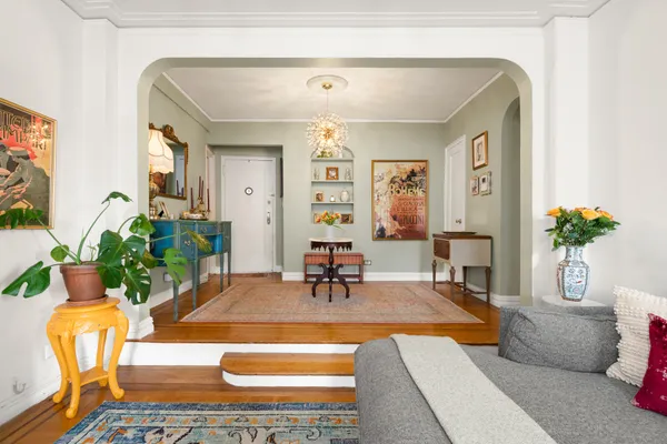 a living room with furniture and flowers