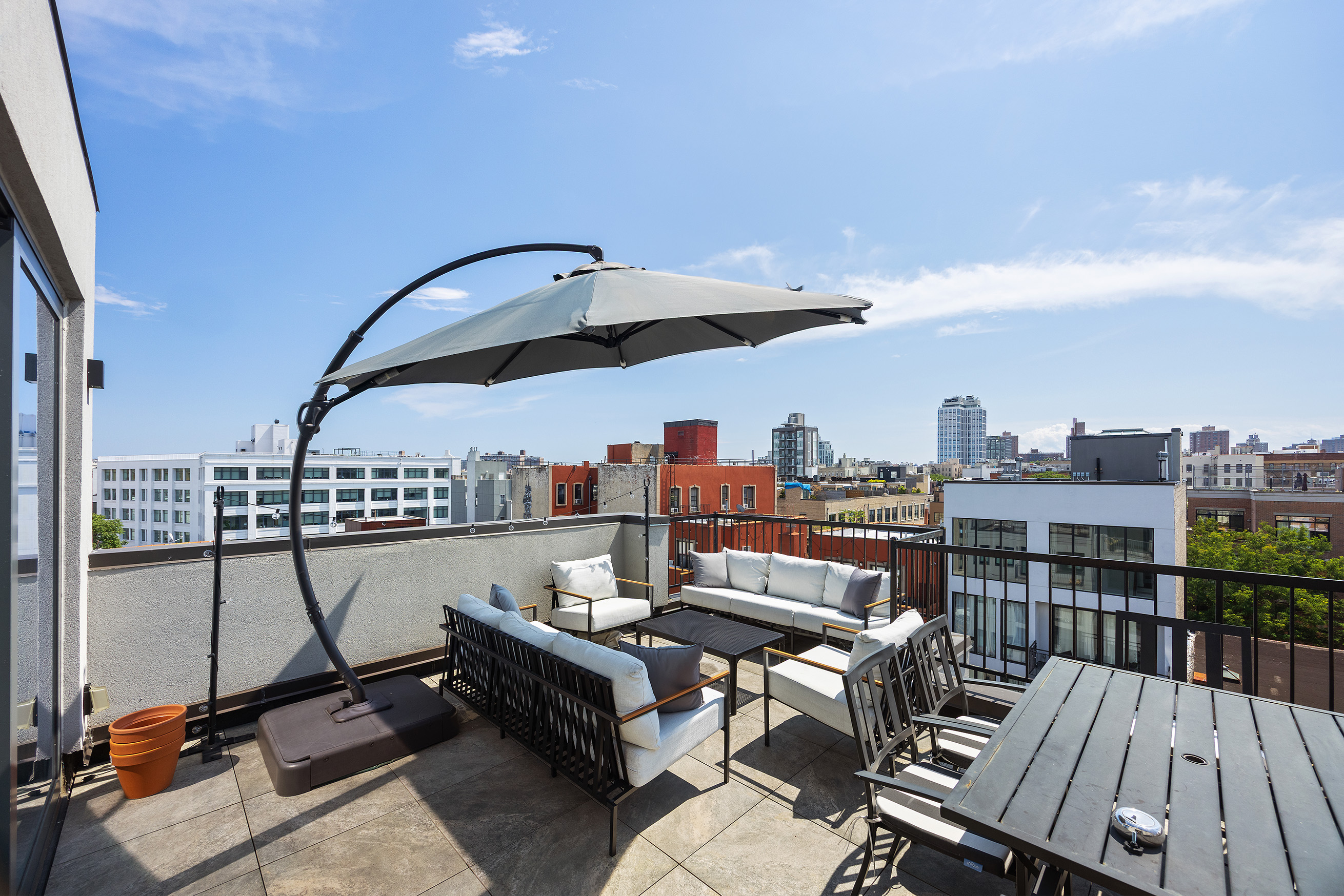 340 Metropolitan Avenue, Unit PHB Brooklyn, NY 11211 - Photo 13 of 18 a view of a roof deck with furniture