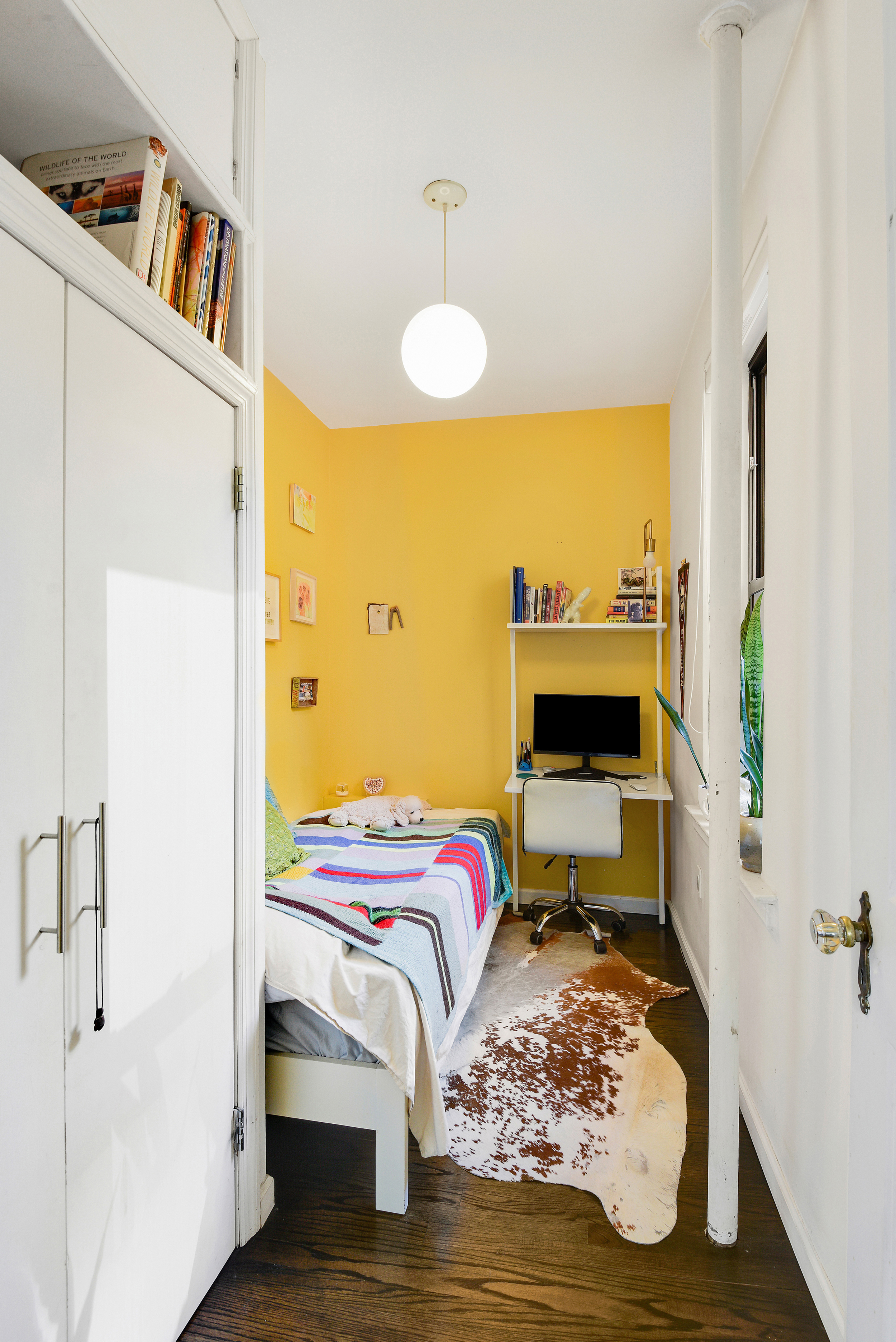 253 West 16th Street, Unit 3A Manhattan, NY 10011 - Photo 11 of 13 a bedroom with a bed and wooden floor