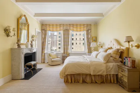 a bedroom with bed and a chandelier