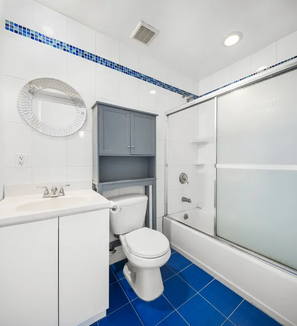 a bathroom with a toilet a sink and a mirror