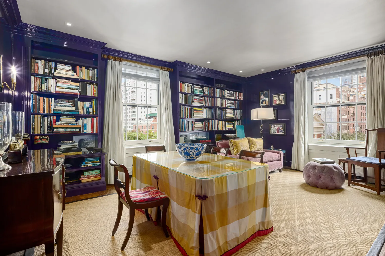 a living room with furniture and a book shelf
