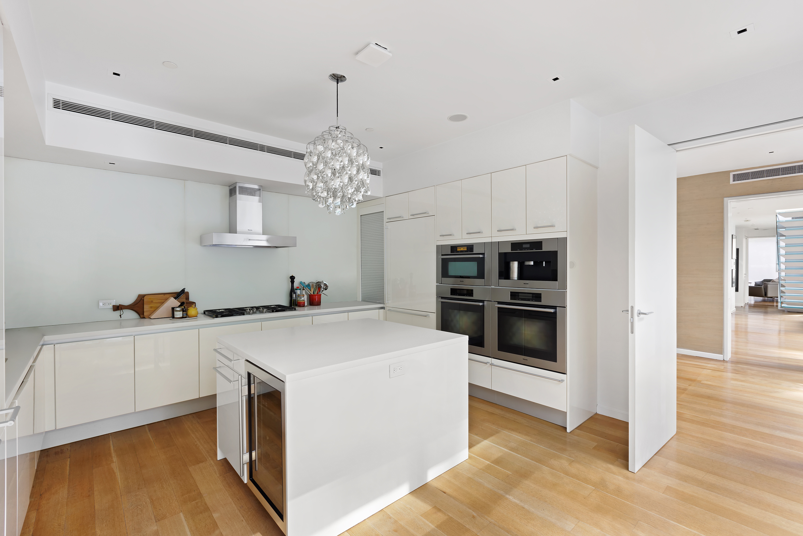 1055 Park Avenue, Unit 1 Manhattan, NY 10028 - Photo 9 of 19 a view of a kitchen with dishwasher and white cabinets
