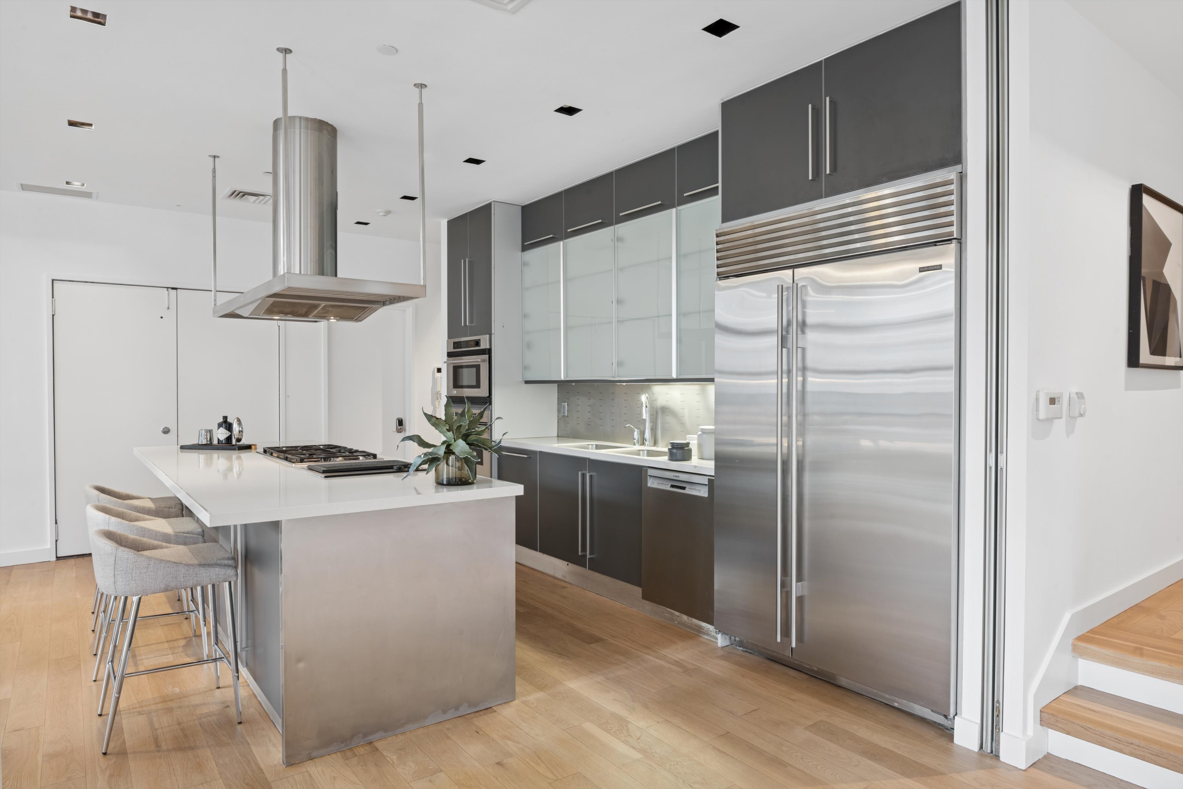 109 West 26th Street, Unit 9 Manhattan, NY 10001 - Photo 7 of 23 a kitchen with stainless steel appliances granite countertop a sink a stove and a refrigerator
