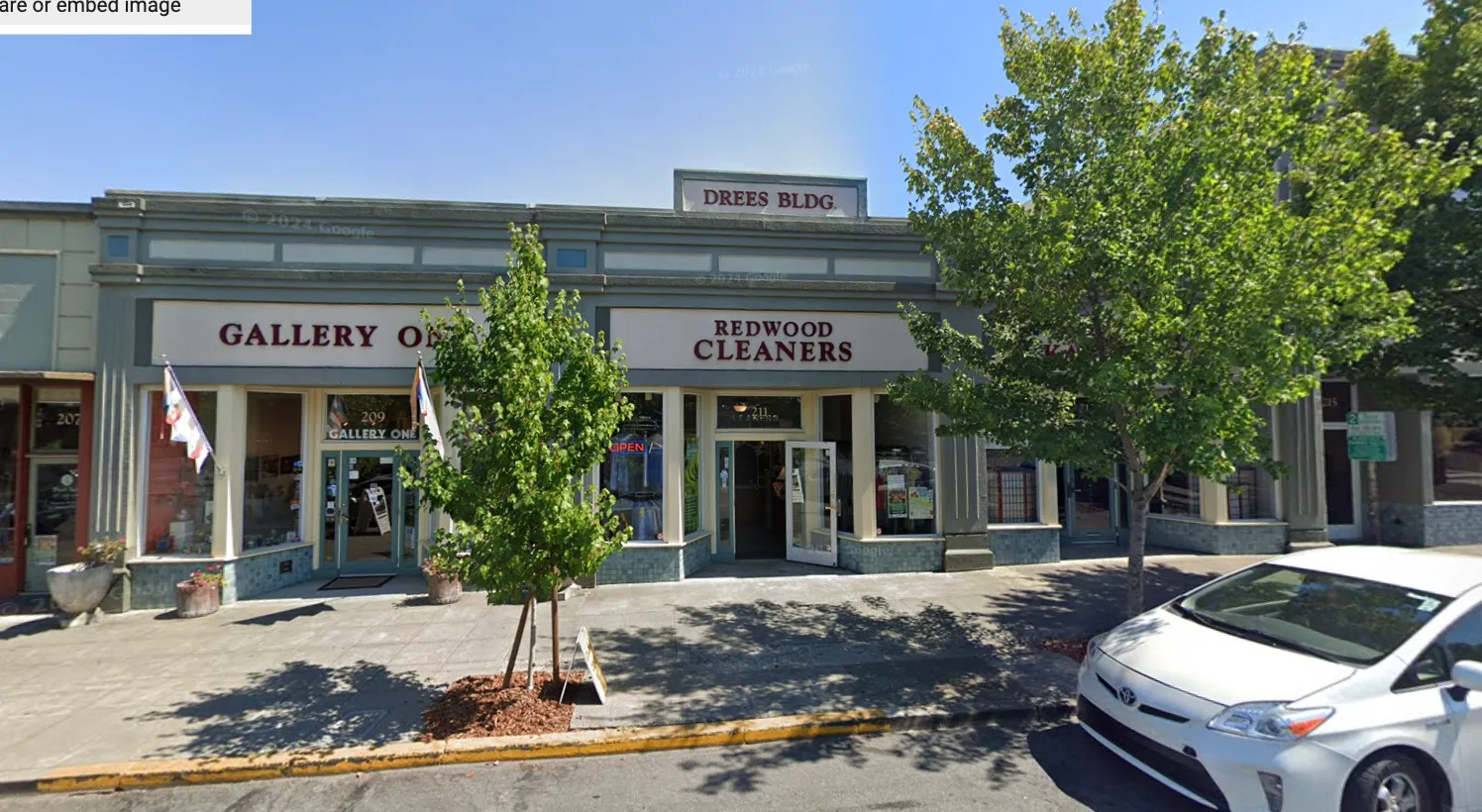 a view of a cars park in front of a building