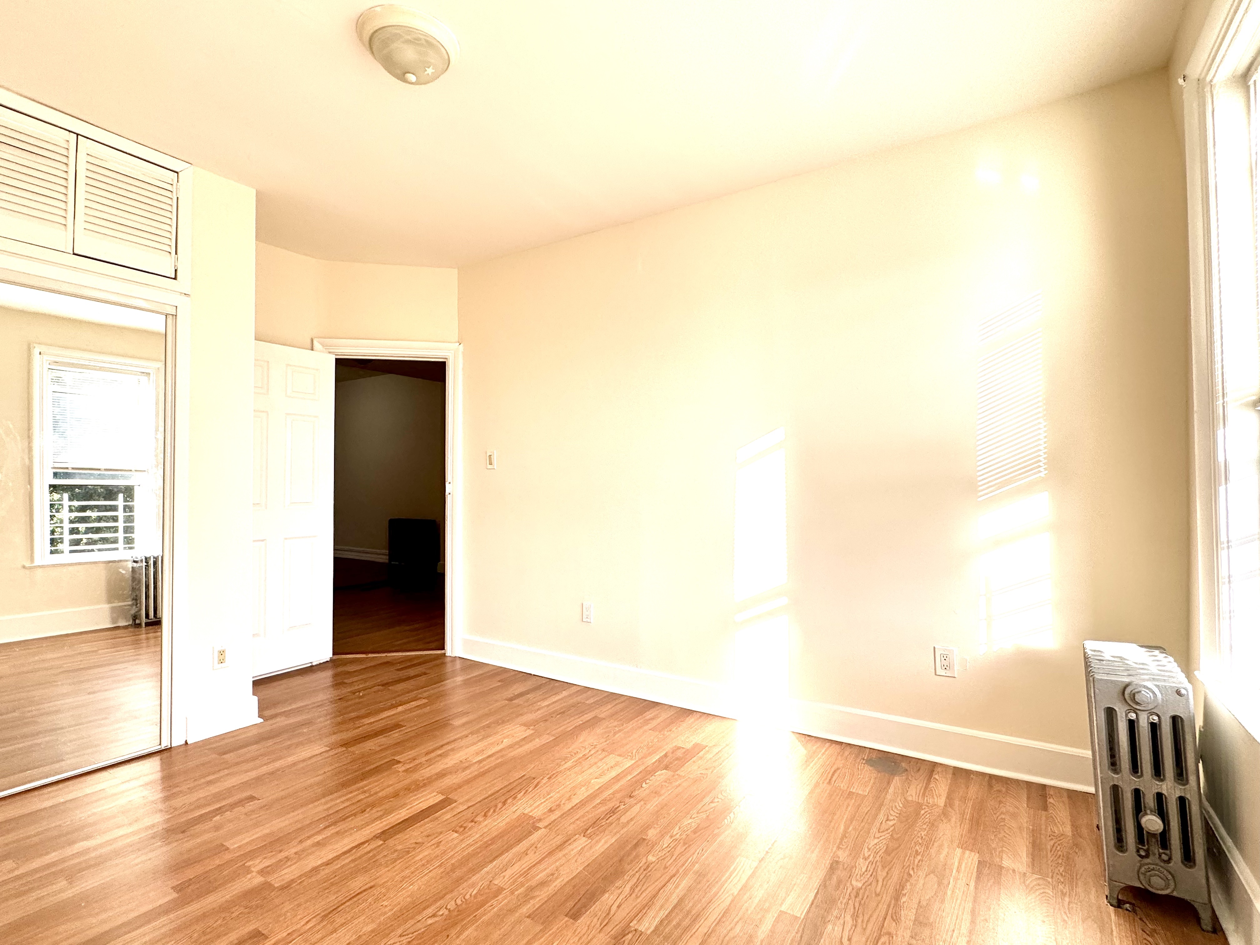 1688 Carroll Street, Unit 2 Brooklyn, NY 11213 - Photo 2 of 9 a view of empty room with wooden floor and fan