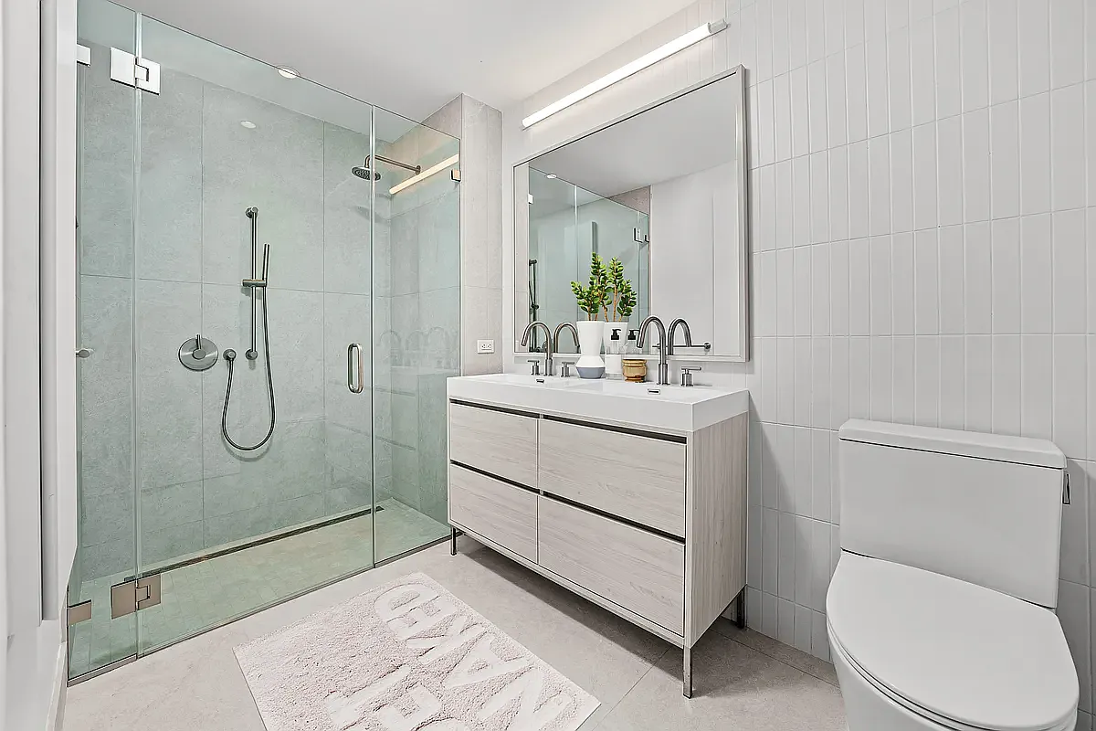 130 2nd Street, Unit 7D Brooklyn, NY 11231 - Photo 7 of 19 a bathroom with a sink a toilet and shower