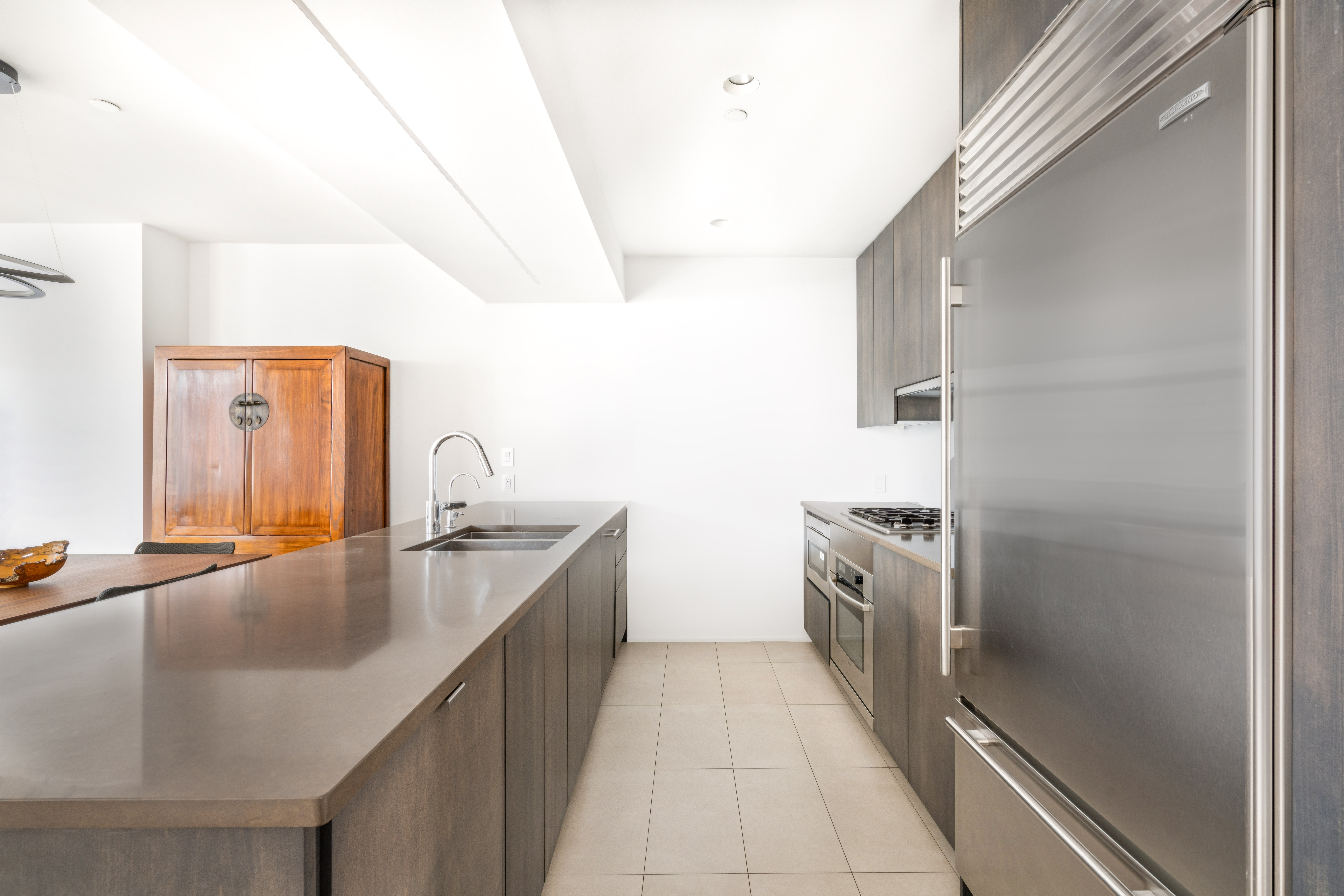 125 West 22nd Street, Unit 10A Manhattan, NY 10011 - Photo 6 of 11 a kitchen with a sink and a refrigerator
