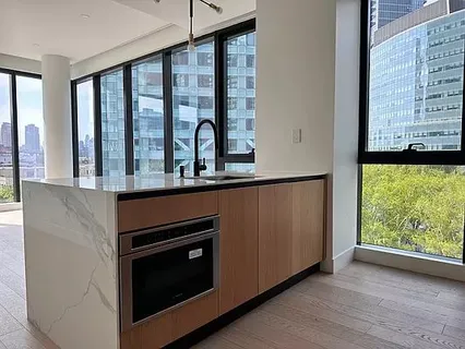 a kitchen with stainless steel appliances granite countertop a stove and a microwave