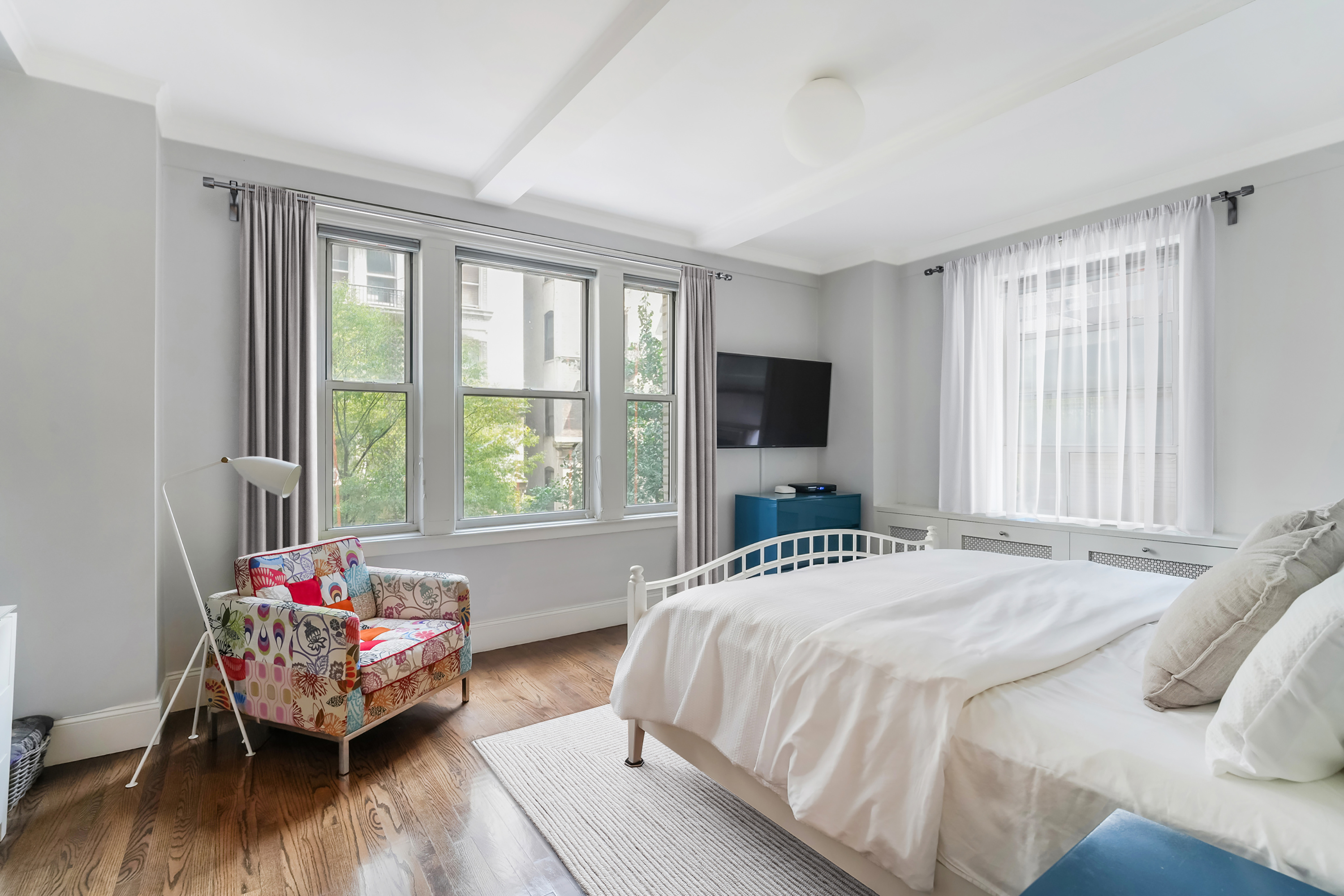 240 West 98th Street, Unit 3D Manhattan, NY 10025 - Photo 6 of 12 a bedroom with a bed and a couch