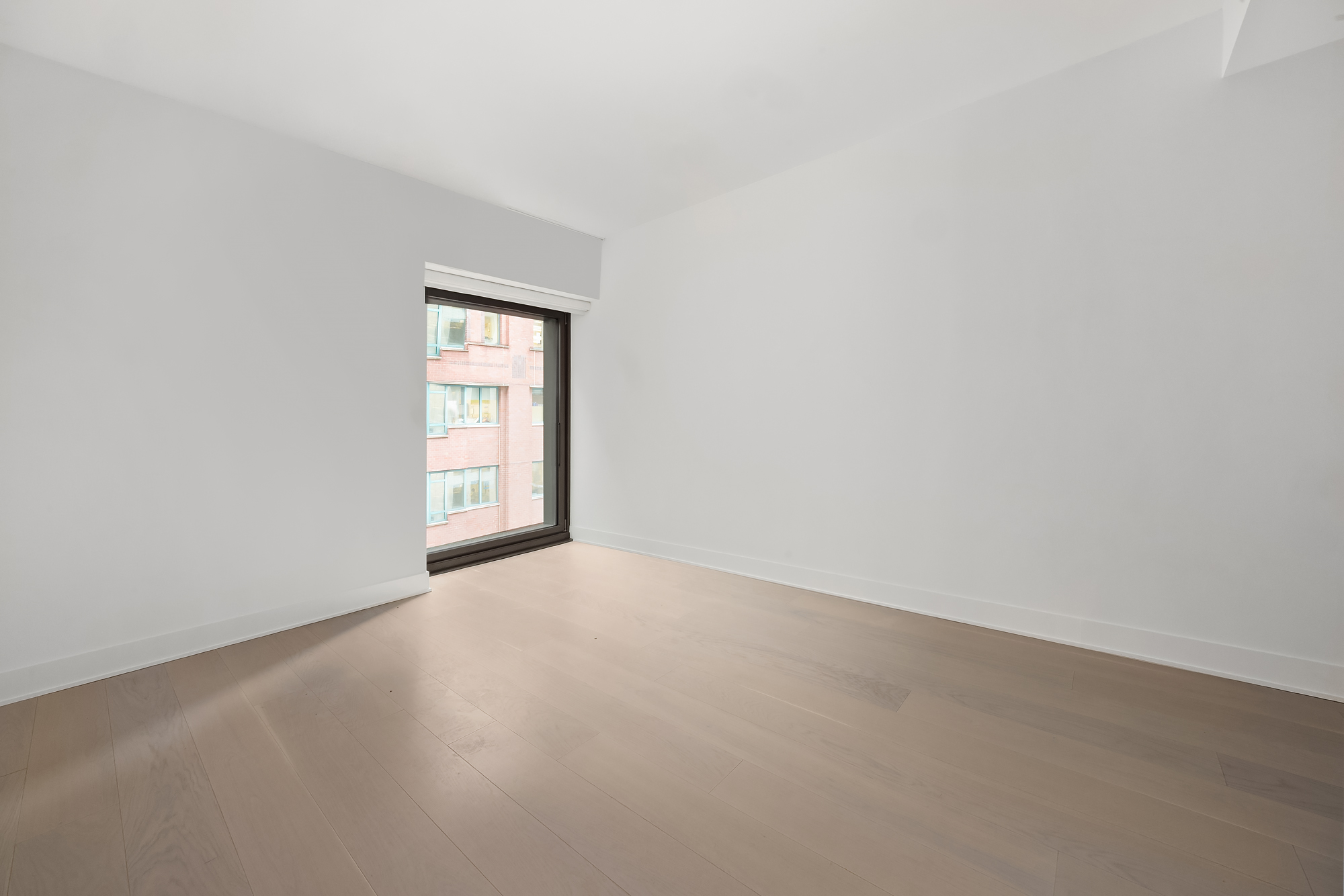 55 West 17th Street, Unit 603 Manhattan, NY 10011 - Photo 5 of 9 an empty room with a window
