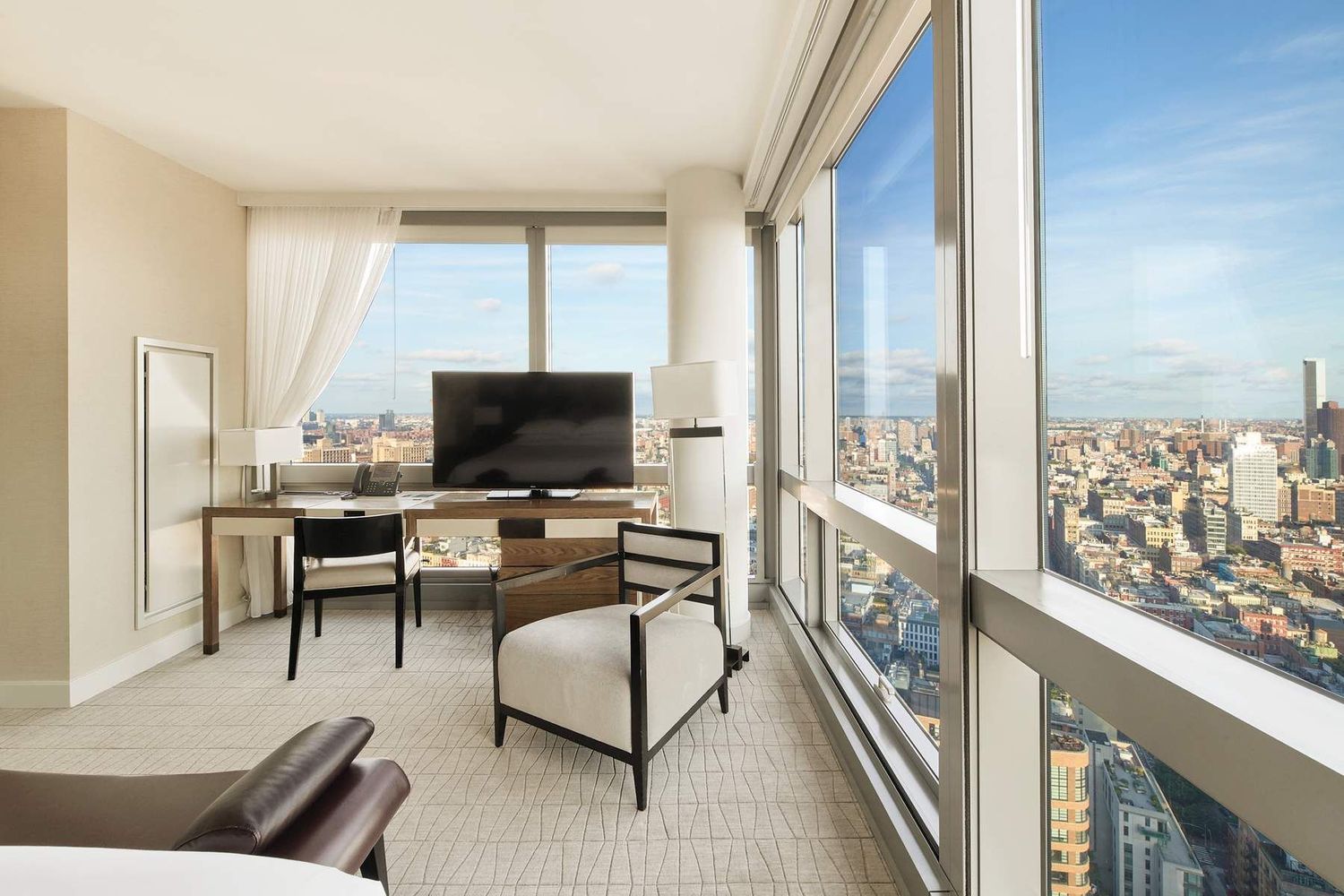 246 Spring Street, Unit 4103 Manhattan, NY 10013 - Photo 3 of 20 a living room with furniture and a flat screen tv