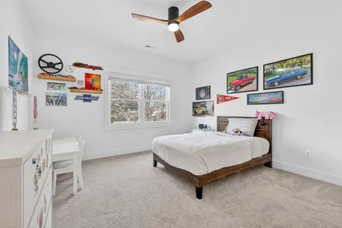 a spacious bedroom with a bed and a chandelier