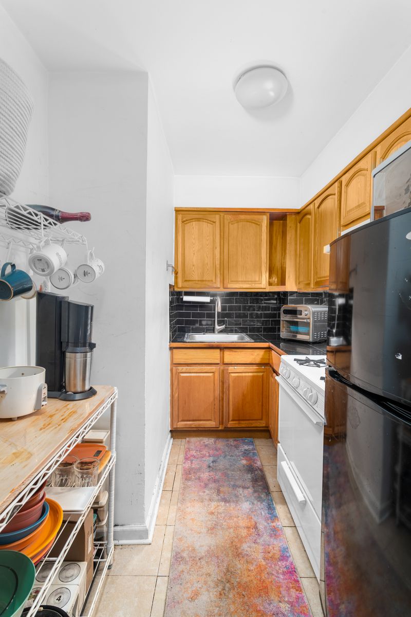227 Ocean Parkway, Unit 7F Brooklyn, NY 11218 - Photo 5 of 7 a kitchen with a sink appliances and cabinets