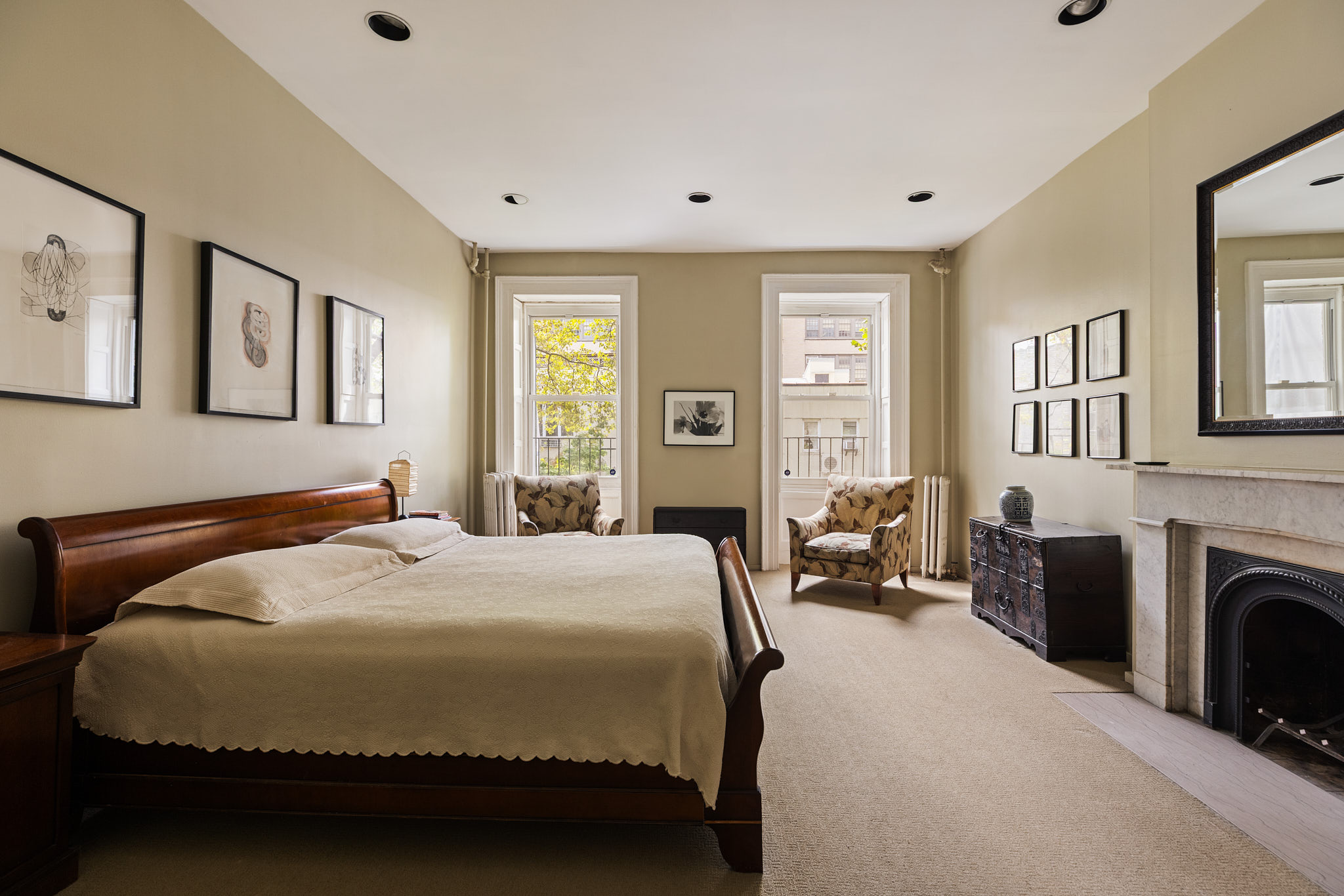 348 West 20th Street Manhattan, NY 10011 - Photo 11 of 18 a bedroom with a bed couch and a fireplace