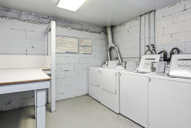 72 East 3rd Street, Unit 5A Manhattan, NY 10003 - Photo 10 of 16 a utility room with cabinets washer and dryer