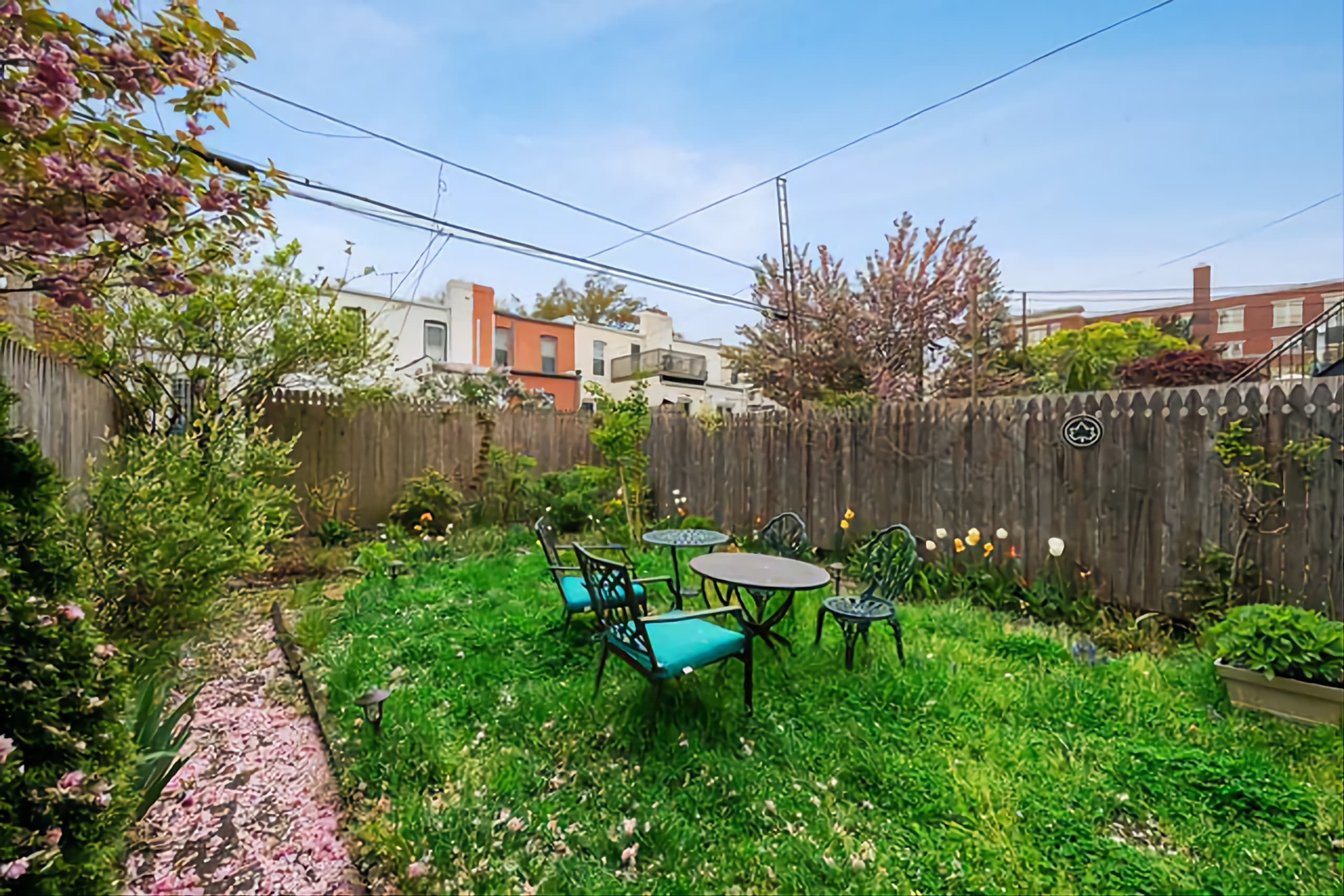 292 Windsor Place, Unit GARDEN Brooklyn, NY 11218 - Photo 6 of 7 a backyard of a house with table and chairs