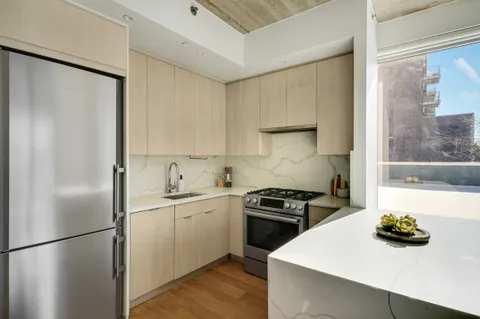 a kitchen with a sink a stove and refrigerator
