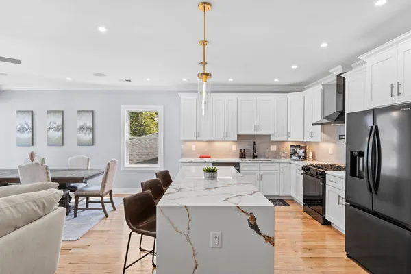a kitchen that has a lot of cabinets a sink and a refrigerator