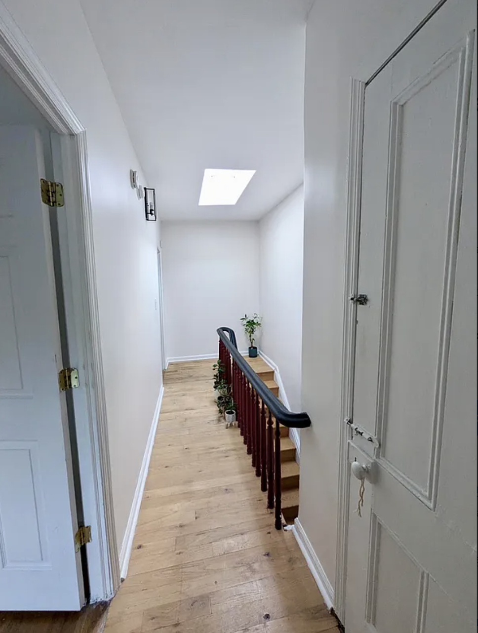 582 Monroe Street, Unit 2 Brooklyn, NY 11221 - Photo 14 of 18 a view of a hallway with wooden floor and staircase