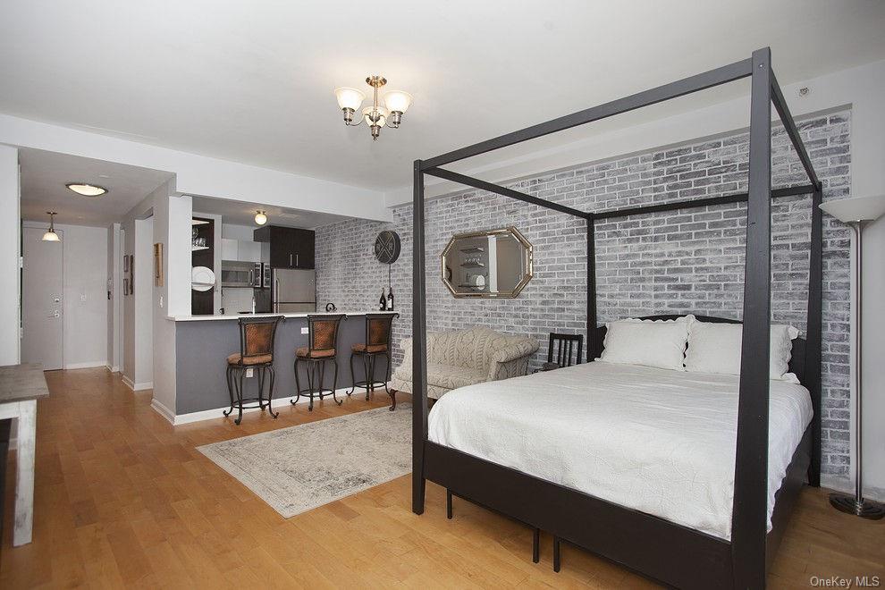 13-11 Jackson Avenue, Unit 4C Queens, NY 11101 - Photo 2 of 7 a bedroom with a bed a mirror and desk