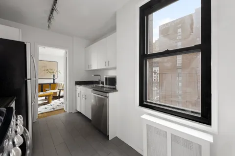 a kitchen with stainless steel appliances a refrigerator and a stove top oven