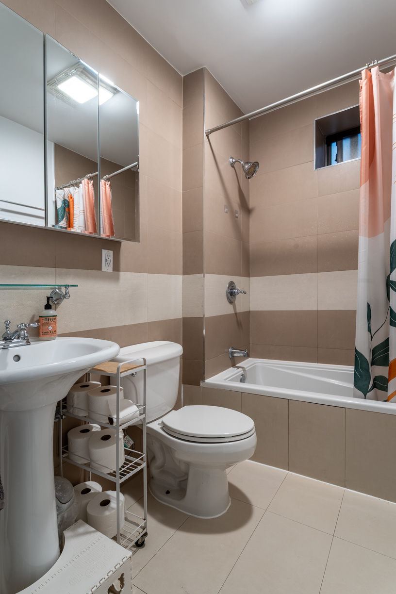 119 East 101st Street, Unit 1A Manhattan, NY 10029 - Photo 8 of 10 a bathroom with a sink toilet and shower