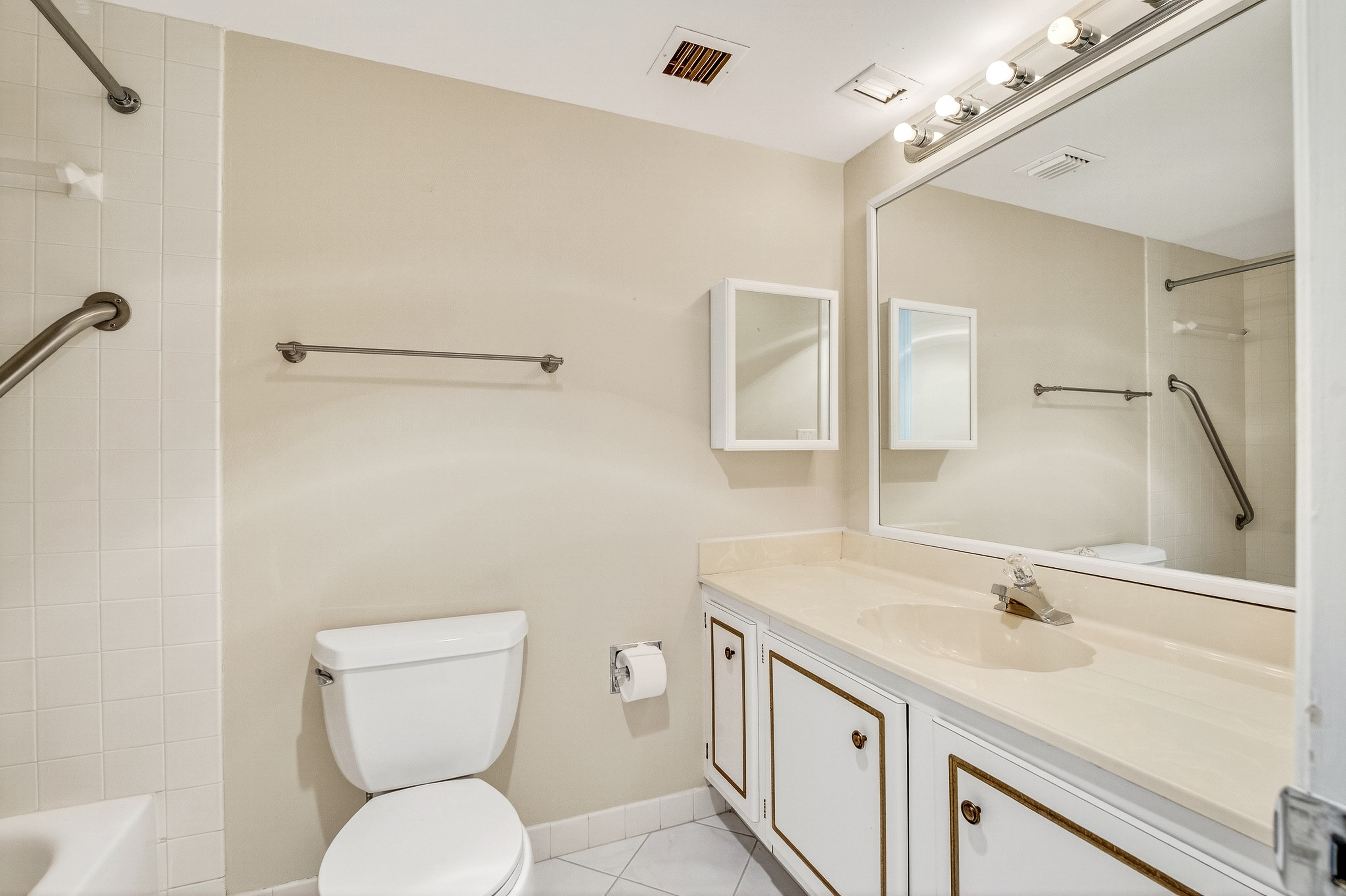 4601 Highway A1a, Unit 102 Vero Beach, FL 32963 - Photo 14 of 29 a bathroom with a toilet sink and mirror