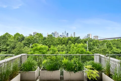 a view of a city with lush green forest