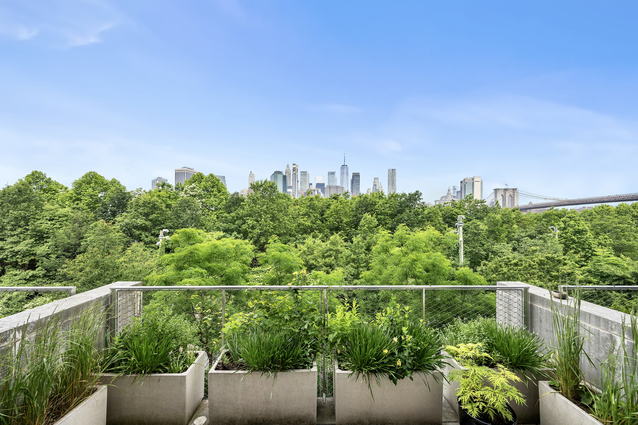 90 Furman Street, Unit N510 Brooklyn, NY 11201 - Photo 4 of 31 a view of a city with lush green forest