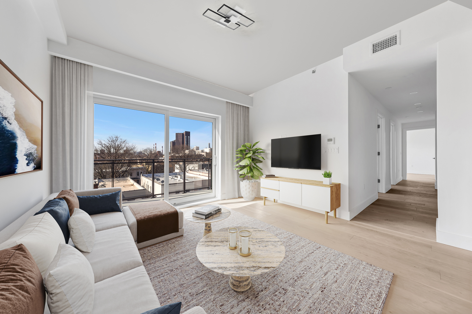 12-16 30th Avenue, Unit 404 Queens, NY 11102 - Photo 5 of 18 a living room with furniture and a flat screen tv