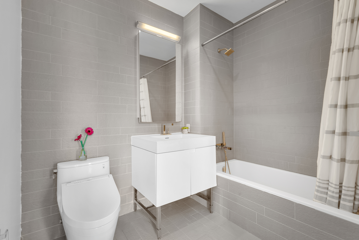 388 Bridge Street, Unit PH50D Brooklyn, NY 11201 - Photo 9 of 29 a bathroom with a sink and mirror with toilet