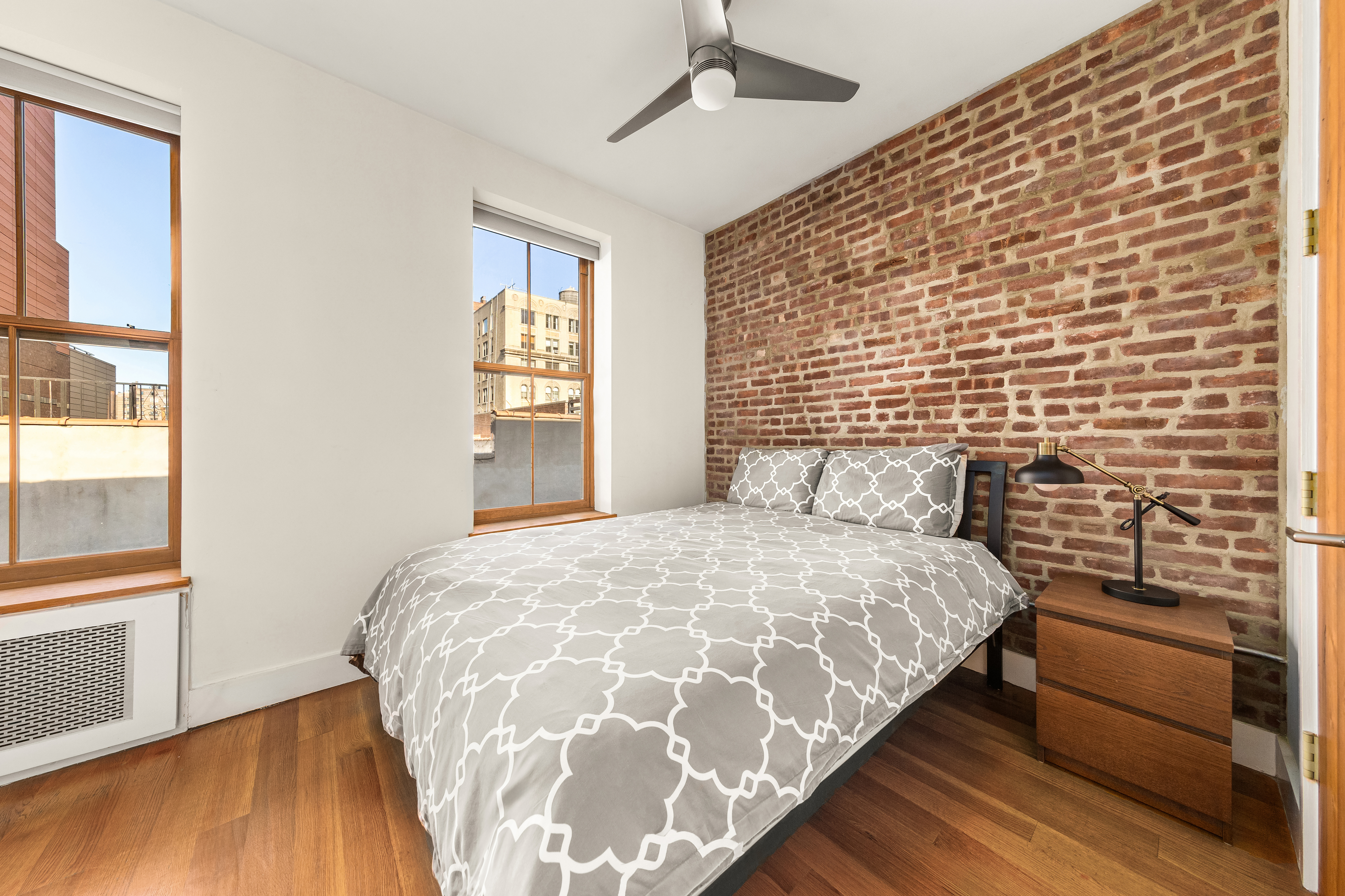 7 West 92nd Street, Unit 76 Manhattan, NY 10025 - Photo 4 of 11 a bedroom with a bed and wooden floor