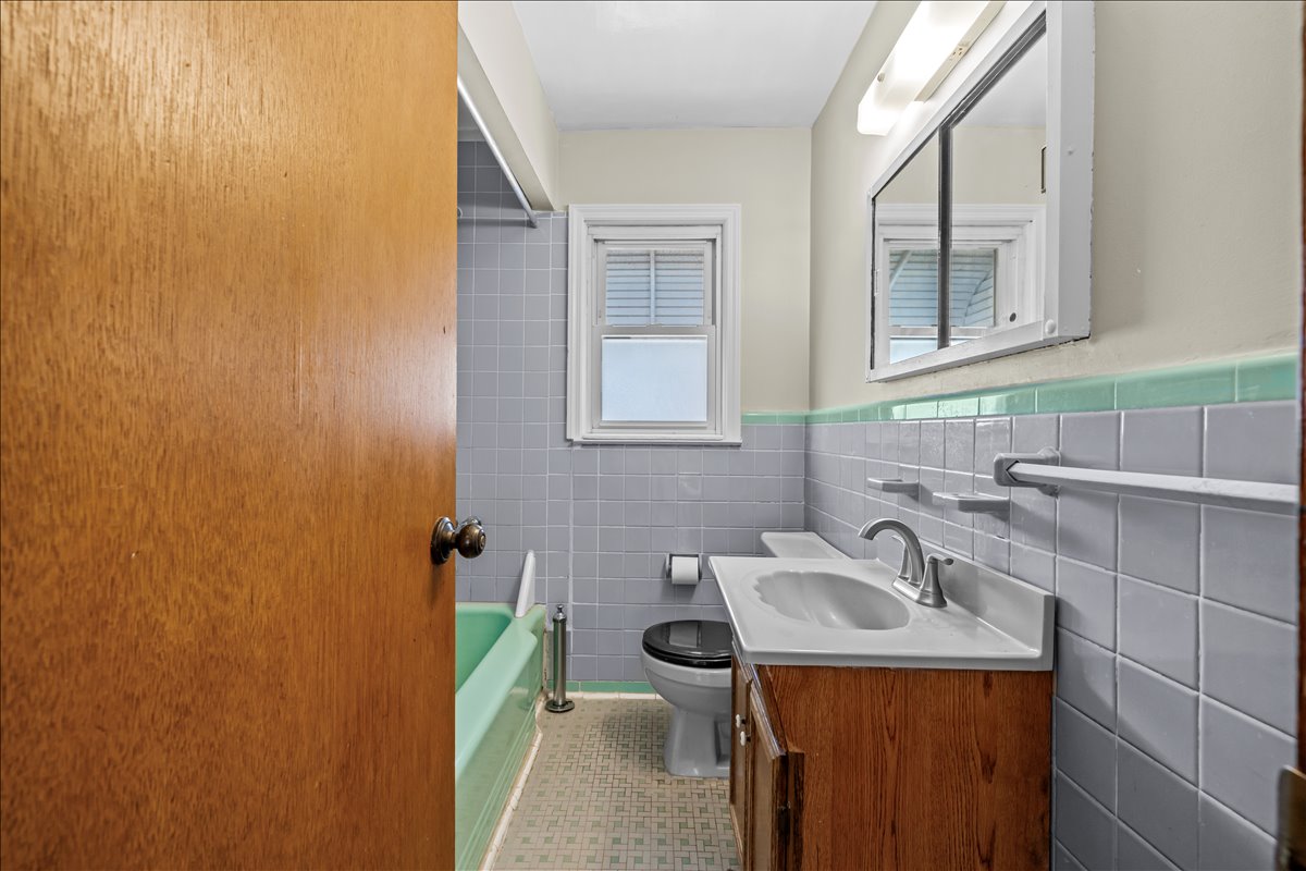 100-14 159th Avenue Queens, NY 11414 - Photo 15 of 26 a bathroom with a sink a toilet and mirror