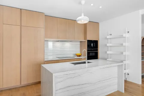 a kitchen with granite countertop white cabinets and stainless steel appliances
