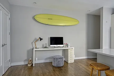 a view of a workspace with wooden floor