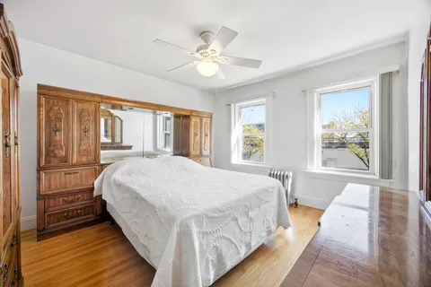 a bed sitting in a bedroom next to a window