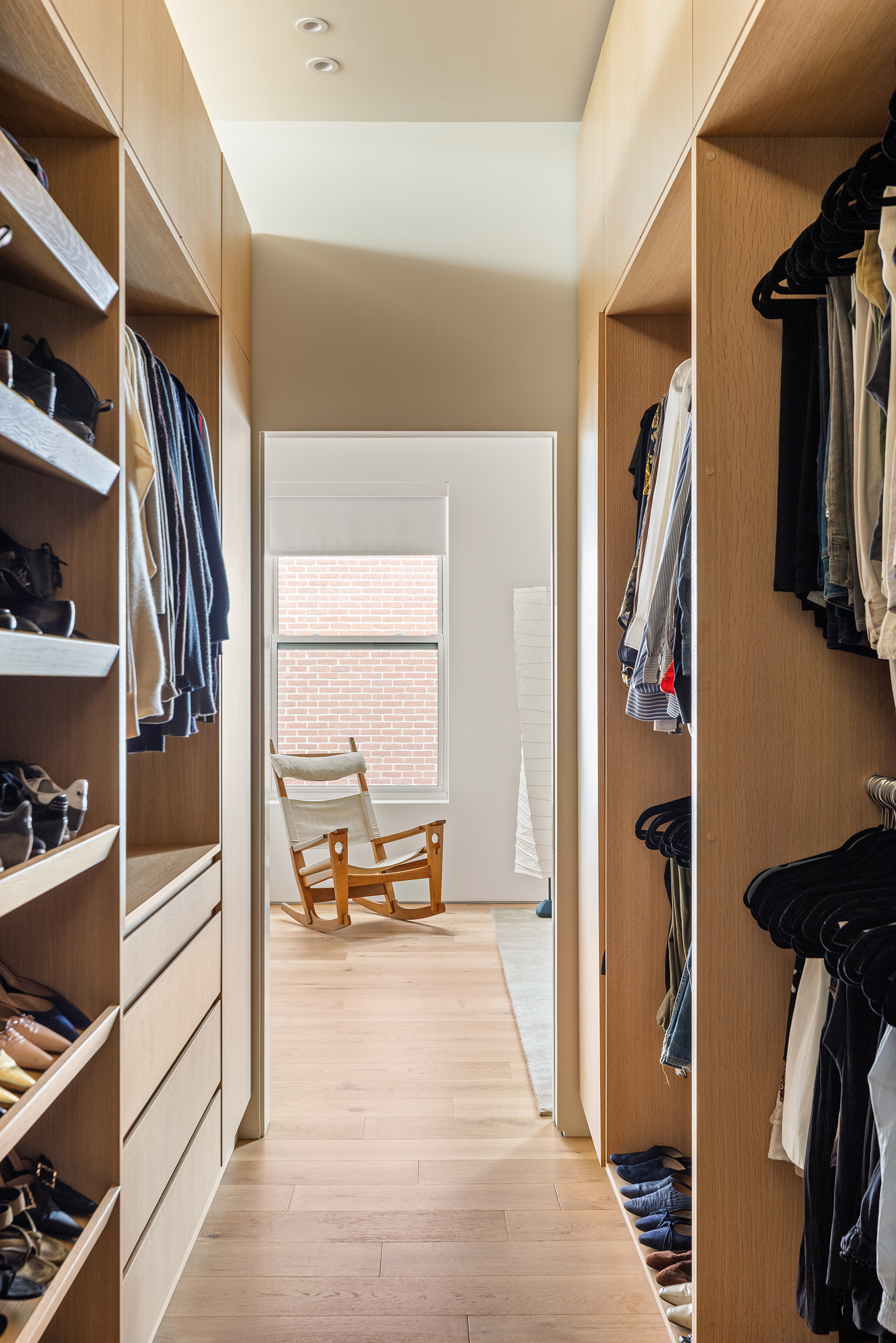 477 Broome Street Manhattan, NY 10013 - Photo 8 of 18 a view of walk in closet with clothes and shoes