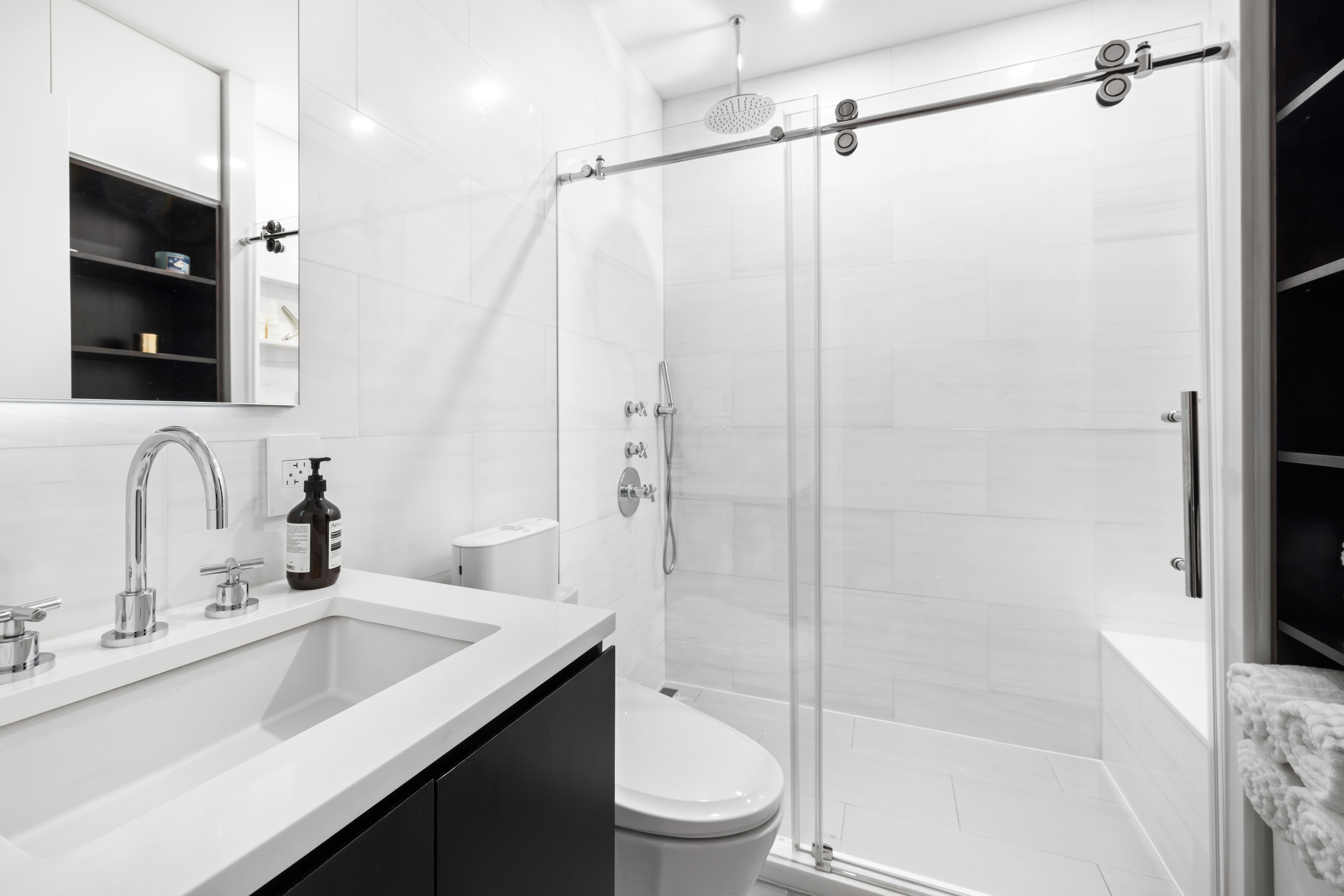 17 East 17th Street, Unit 4 Manhattan, NY 10003 - Photo 7 of 11 a bathroom with a sink a toilet and shower