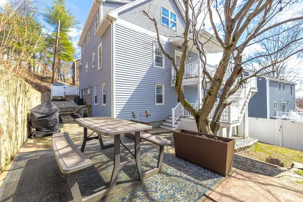 a view of a patio with table and chairs and couches