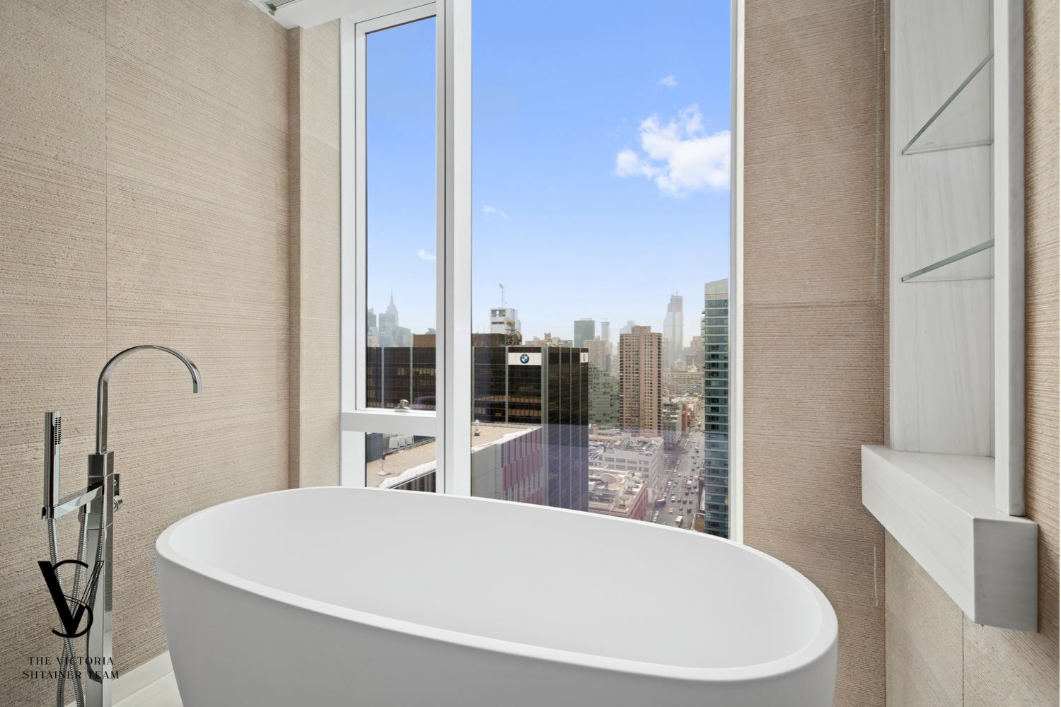 1 West End Avenue, Unit C28 Manhattan, NY 10069 - Photo 8 of 26 a large white tub sitting next to a bathroom sink and a shower