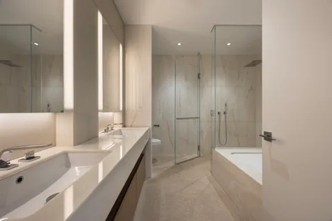 a bathroom with a tub sink and mirror