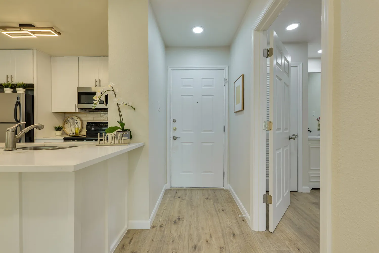 a kitchen with kitchen island a sink stainless steel appliances and cabinets