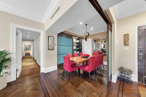 a view of a dining room with furniture and wooden floor