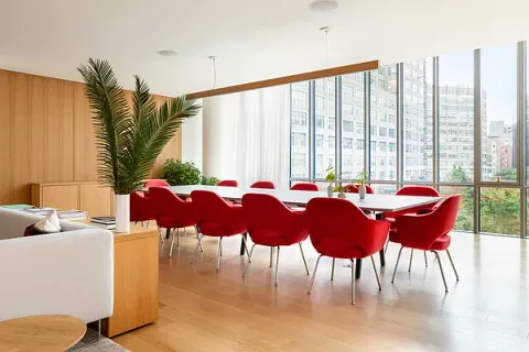 a living room with furniture and a book shelf