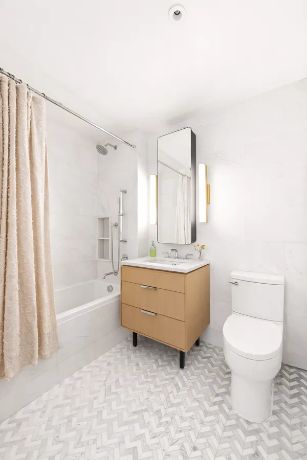 a bathroom with a granite countertop toilet a sink and bathtub