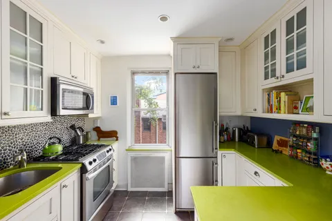 a kitchen with a refrigerator and a sink