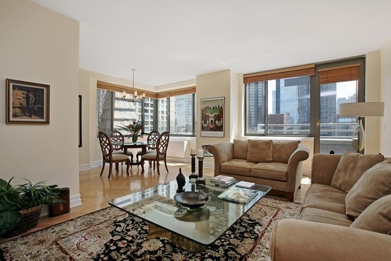 2 Columbus Avenue, Unit 16B Manhattan, NY 10023 - Photo 2 of 5 a living room with furniture and a large window