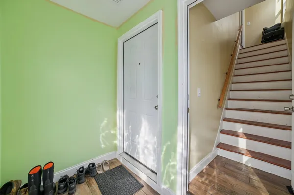 a view of hallway with wooden floor and stairs